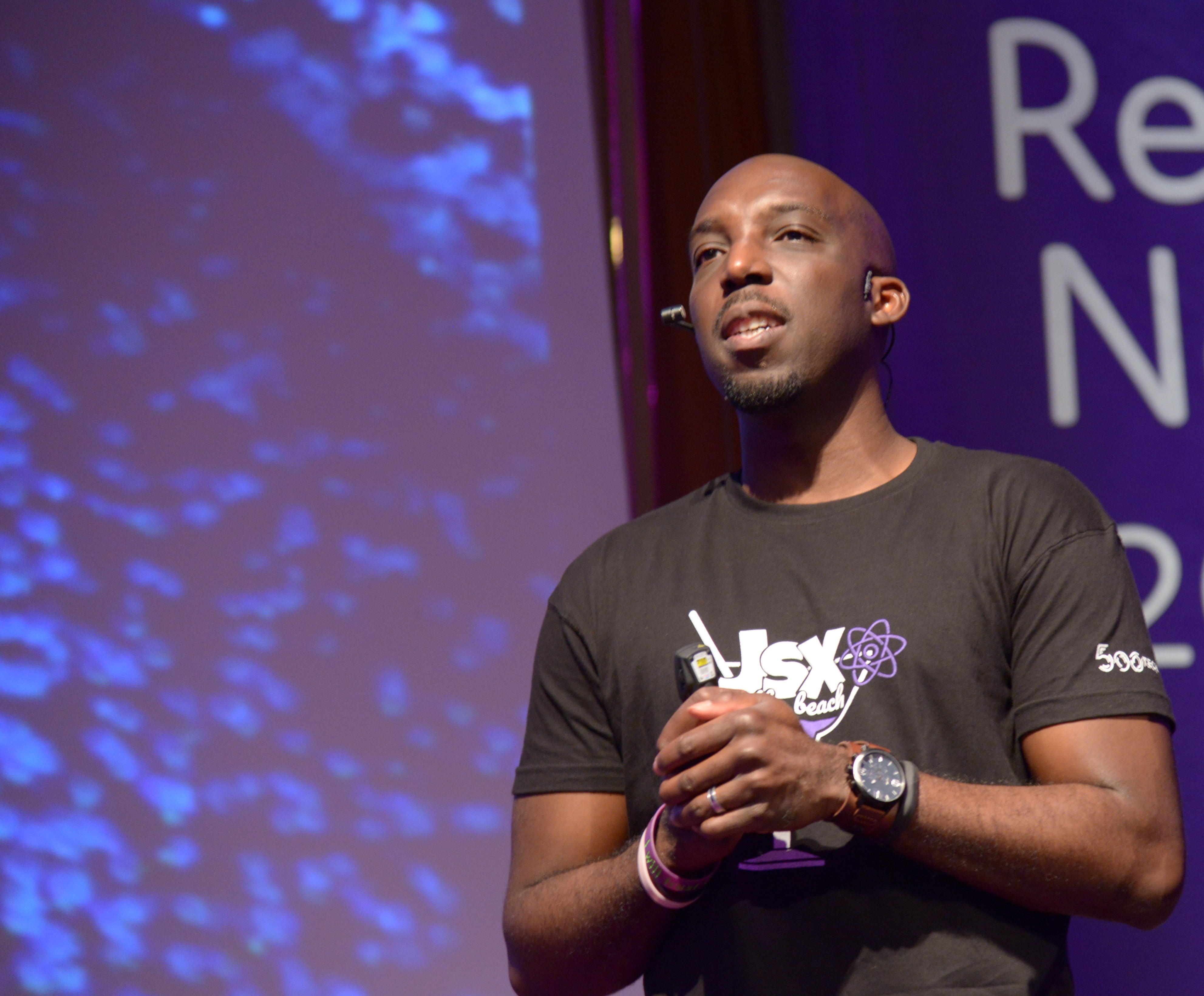 A cropped image of Ben Ilegbodu speaking at a conference